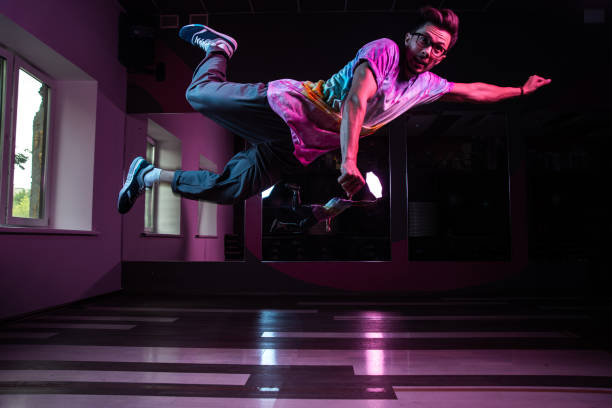 istock Professional break dancer in motion, practicing modern hip-hop dance in pink neon light 1284929334