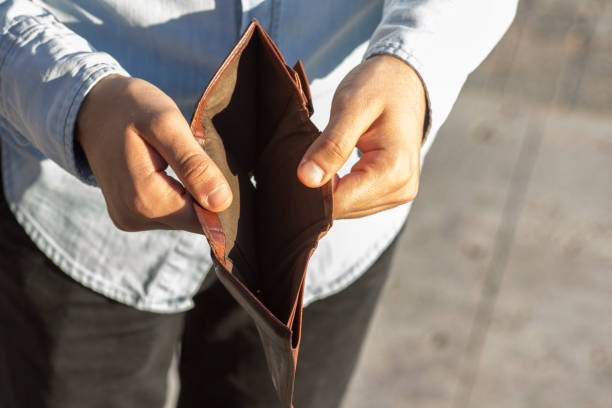 istock young man with no money in his wallet 1284929357