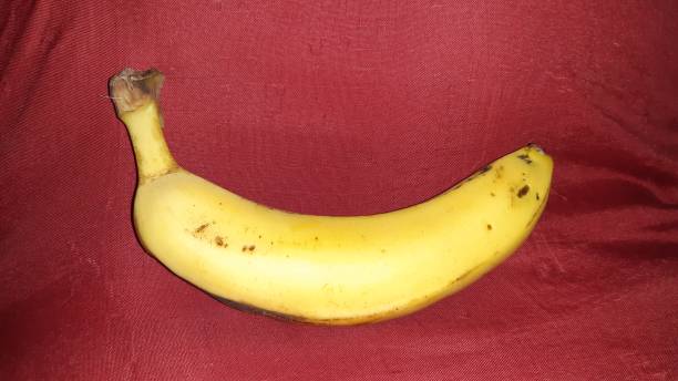 istock A yellow banana in red background 1284933294
