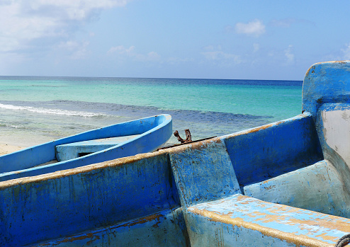 Brighty Painted Blue Boats Drawn up on the Beach