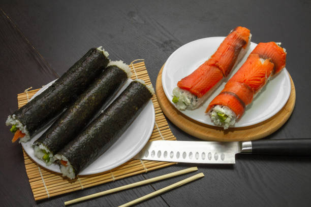 istock Sushi. Freshly cooked rolls of two types and ready to cut. 1284934623
