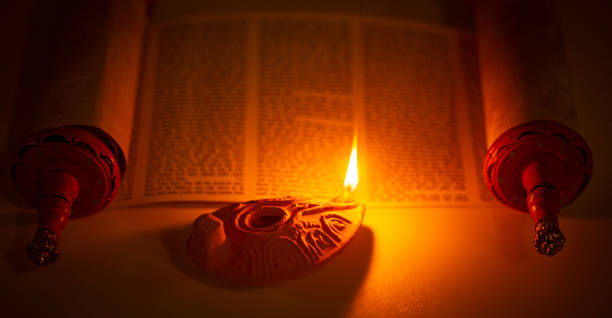 An Ancient Lamp Illuminating the Hebrew Text of the Torah stock photo