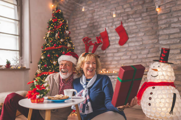 istock Senior couple exchanging Christmas presents 1284937162