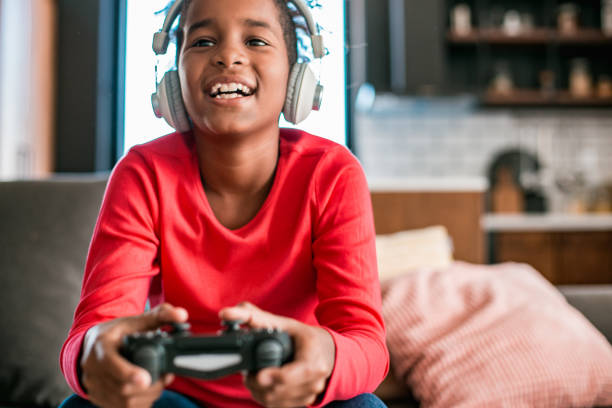 istock Young girl playing video games at home 1284937741
