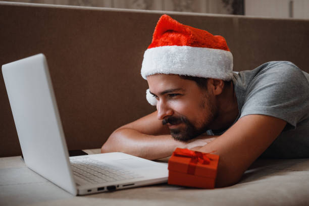 istock A hipster man with a red cup sitting at home at Christmas time. 1284938548