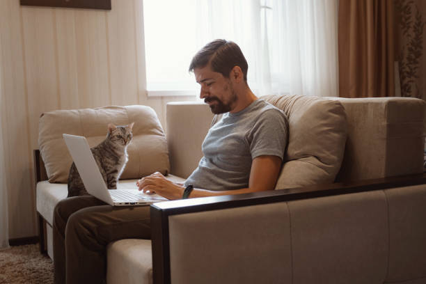 istock Young attractive smiling guy is browsing at his laptop 1284938698