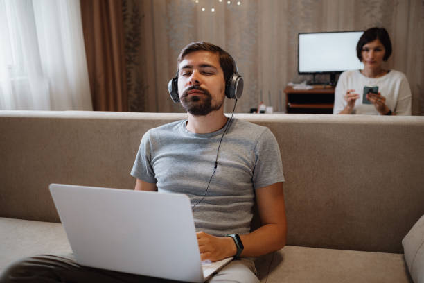 istock Couple Working And Playing With Laptop Computer At Home 1284938944