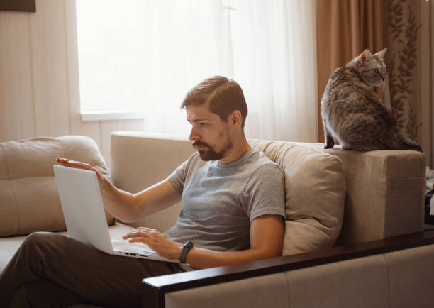 istock Young attractive smiling guy is browsing at his laptop 1284939121