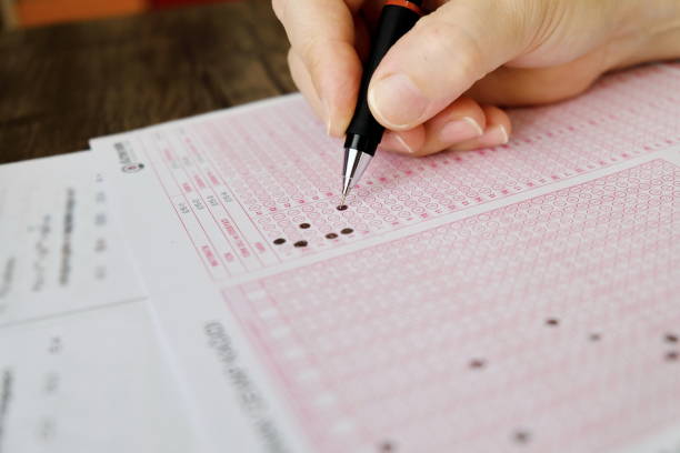 istock A student hand holding a pencil to do an exam 1284939327