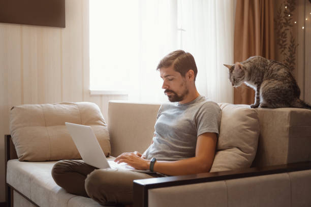 istock Young attractive smiling guy is browsing at his laptop 1284939463