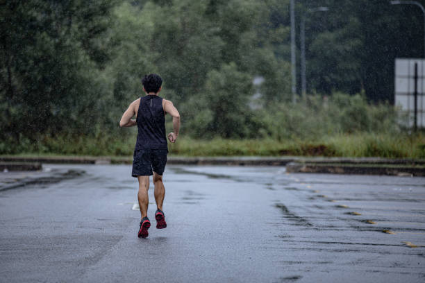 istock Asian Chinese mature man running in  rainy day. 1284939506