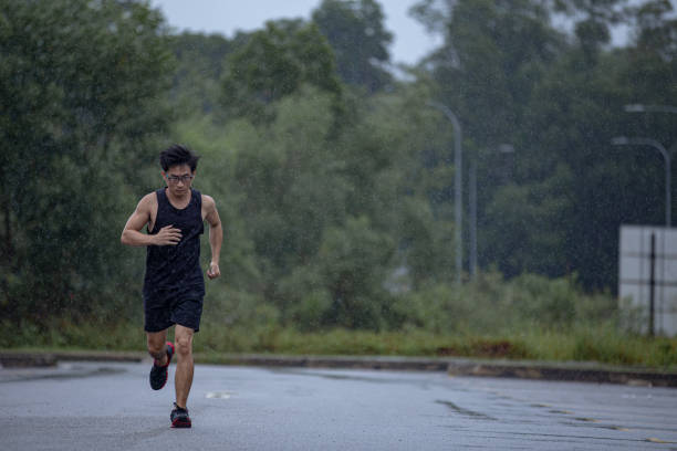 istock Asian Chinese mature man running in  rainy day. 1284939512