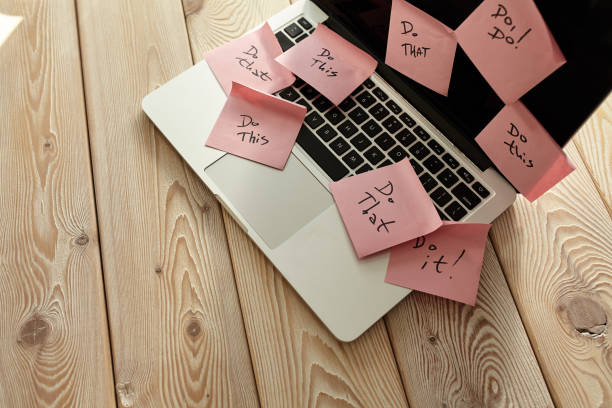 istock Image of laptop full of sticky notes reminders on screen. Work overload concept image. Coworking or working at home concept image. 1284941712