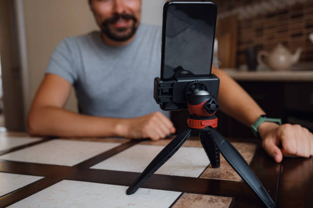 istock Young man having video call via smartphone in the home office. 1284942579
