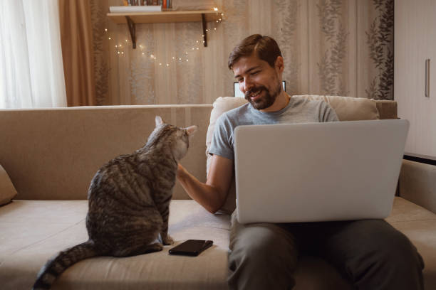 istock Young attractive smiling guy is browsing at his laptop 1284942638