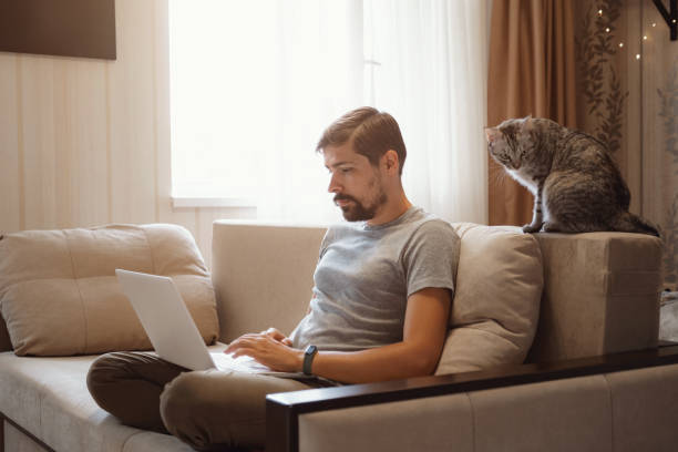 istock Young attractive smiling guy is browsing at his laptop 1284943222