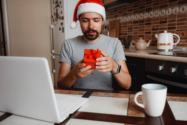 istock A hipster man with a red cup sitting at home at Christmas time. 1284943649