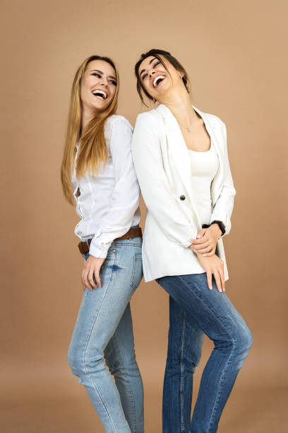istock Portrait two laughing young women on a beige background 1284944650