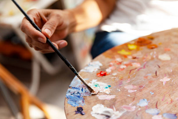 istock Close up  holding color palette with paintbrush 1284944701