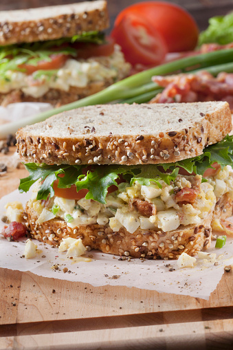 Egg Salad Sandwich with Crispy Bacon, Lettuce and Tomato on Whole Grain Bread