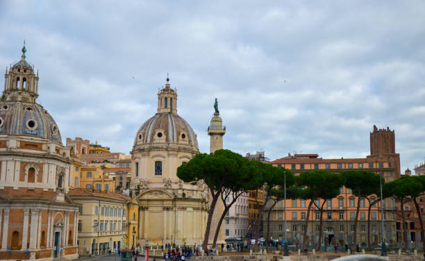 istock Trajan Column, Catholic churches and pine trees at Piazza Venezia, Rome, Italy 1284945222