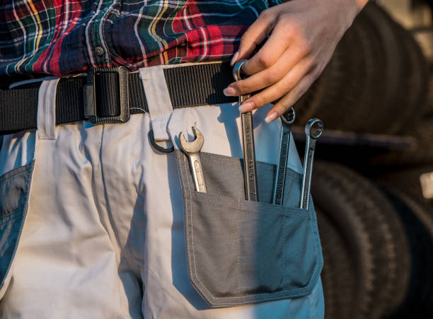 istock Female car mechanic pocket, female hand taking tools 1284947399
