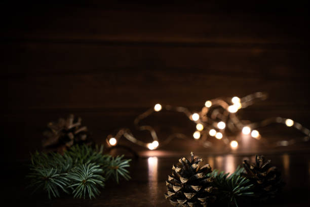 istock 2021 New Year's Eve Bokeh, Pine cones Composition with Text Mock-up Evening Dark Flashlights, Christmas tree lights 1284948011
