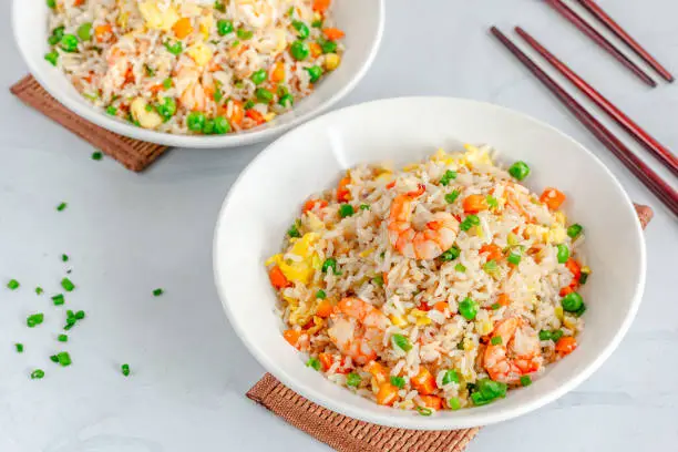 Shrimp Fried Rice in a Bowl with Chopsticks Top Down Flat Lay Photo on White Background