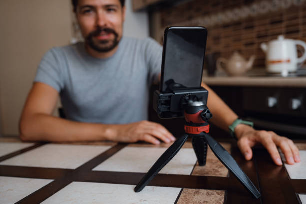 istock Young man having video call via smartphone in the home office. 1284949296