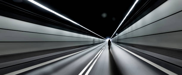 istock Silhouette of a woman in a dark tunnel with a light exit 1284950239