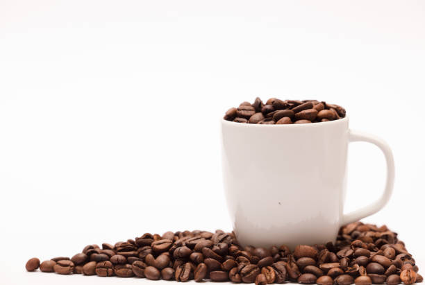 istock white ceramic cup, with coffee beans and white background 1284950380