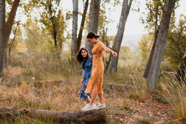 istock A couple of lesbians walking over a fallen tree 1284950621