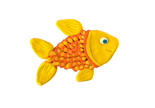 Bright yellow plasticine fish on a white background