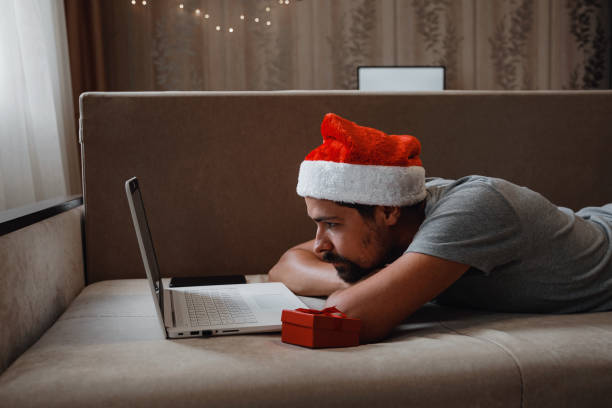istock A hipster man with a red cup sitting at home at Christmas time. 1284950816