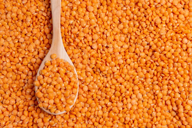 istock red lentils Lens culinaris against, with copy space. Selective focus. texture background 1284950885