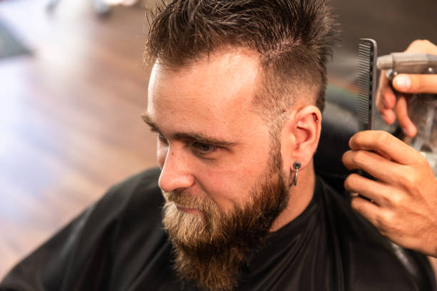 istock man with beard is combed in barbershop and  sprayed with water dispenser 1284952520