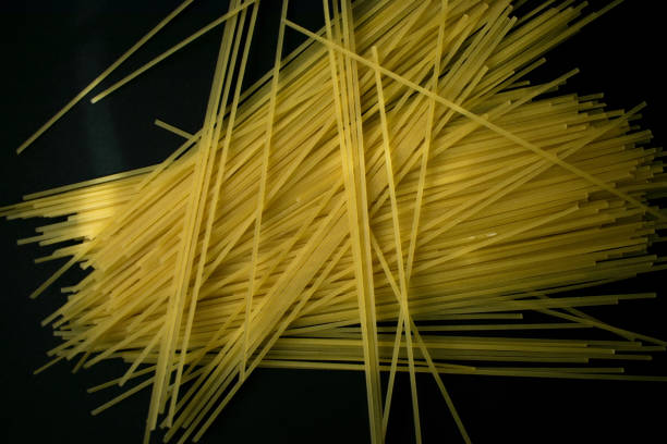 istock linguine pasta number nine in a black background 1284953207