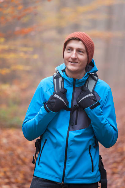 istock Young man hiking with backpack in a forest in fall 1284953747