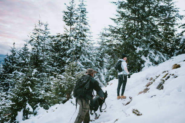 istock Hikers and Dog in Snow Covered Pacific Northwest 1284954411