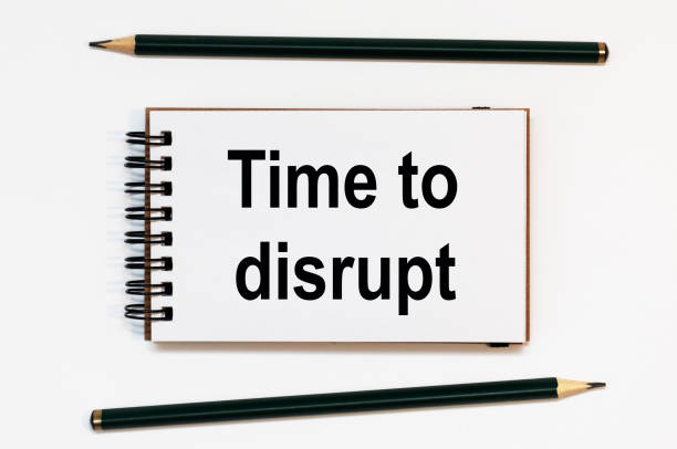 istock WHITE SPIRAL NOTEBOOK, TWO PENCILS WITH TEXT TIME TO DISRUPT 1284954782