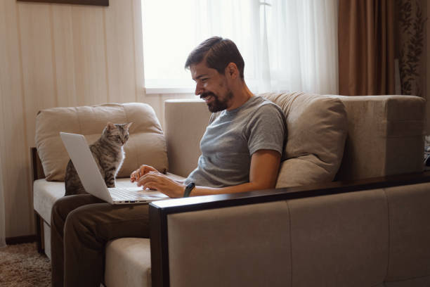 istock Young attractive smiling guy is browsing at his laptop 1284955584