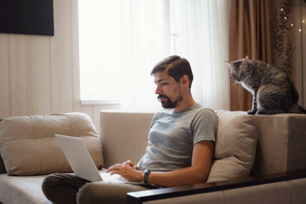 istock Young attractive smiling guy is browsing at his laptop 1284955865