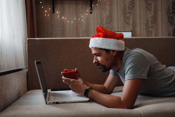 istock A hipster man with a red cup sitting at home at Christmas time. 1284956074