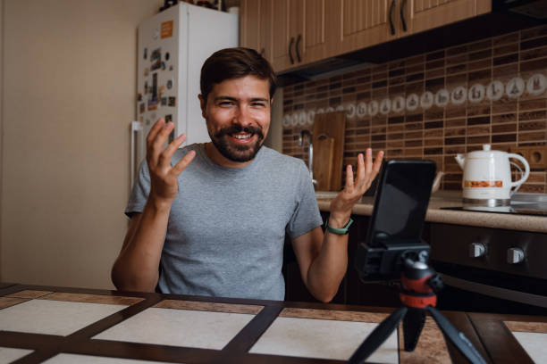 istock Young man having video call via smartphone in the home office. 1284956086