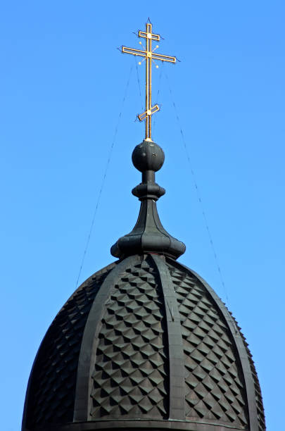 istock Metal cross against the blue sky. 1284958097