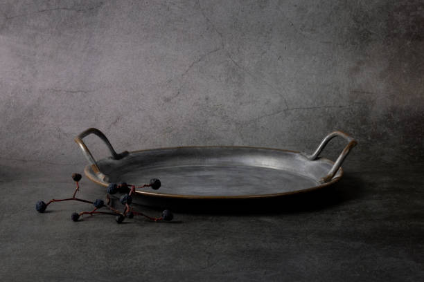 Abstract minimal scene with old metal dish on black background. Metallic plate podium for product presentation. 3d rendering.