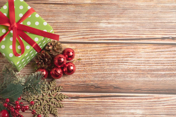 istock Christmas composition. Gift, for tree branches, red balls decorations on wooden background. 1284961044