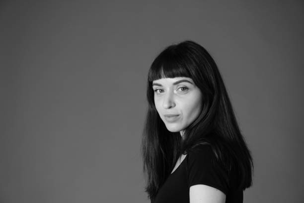 istock Studio portrait of a young woman against plain black background 1284964670