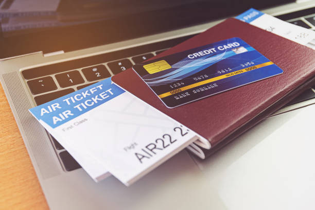 Credit card and passports near laptop computer on table. Online ticket booking concept Credit card and passports near laptop computer on table. Online ticket booking concept airplane ticket photos stock pictures, royalty-free photos & images