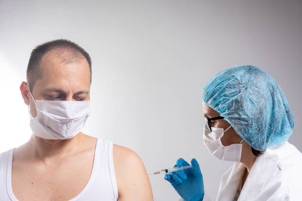 istock Mature man taking a vaccine from his doctor 1284968207